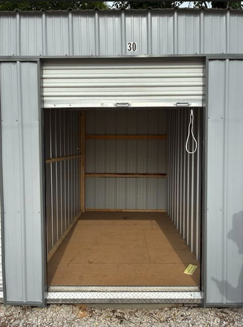 Empty storage unit interior with wood floor